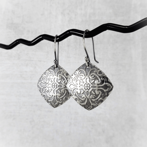 Sterling silver square elegance earrings with intricate embossed detailing, adding a touch of elegance to any outfit.
