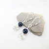 Sterling silver spiral earrings with sapphire gemstone and lever back ear wires.