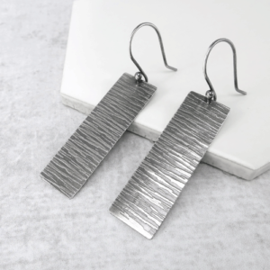 Edgy Elegance Oxidized Rectangle Earrings featuring sleek, oxidized rectangular drops hanging from delicate French ear wires, showcasing a unique artisanal finish and modern design.
