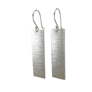 A pair of rectangular earrings with a horizontal line pattern, known as 