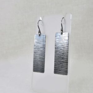Edgy Elegance Oxidized Rectangle Earrings featuring sleek, oxidized rectangular drops hanging from delicate French ear wires, showcasing a unique artisanal finish and modern design.