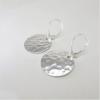 Hammered Harmony: Sterling silver earrings with hammered discs and lever back ear wires.